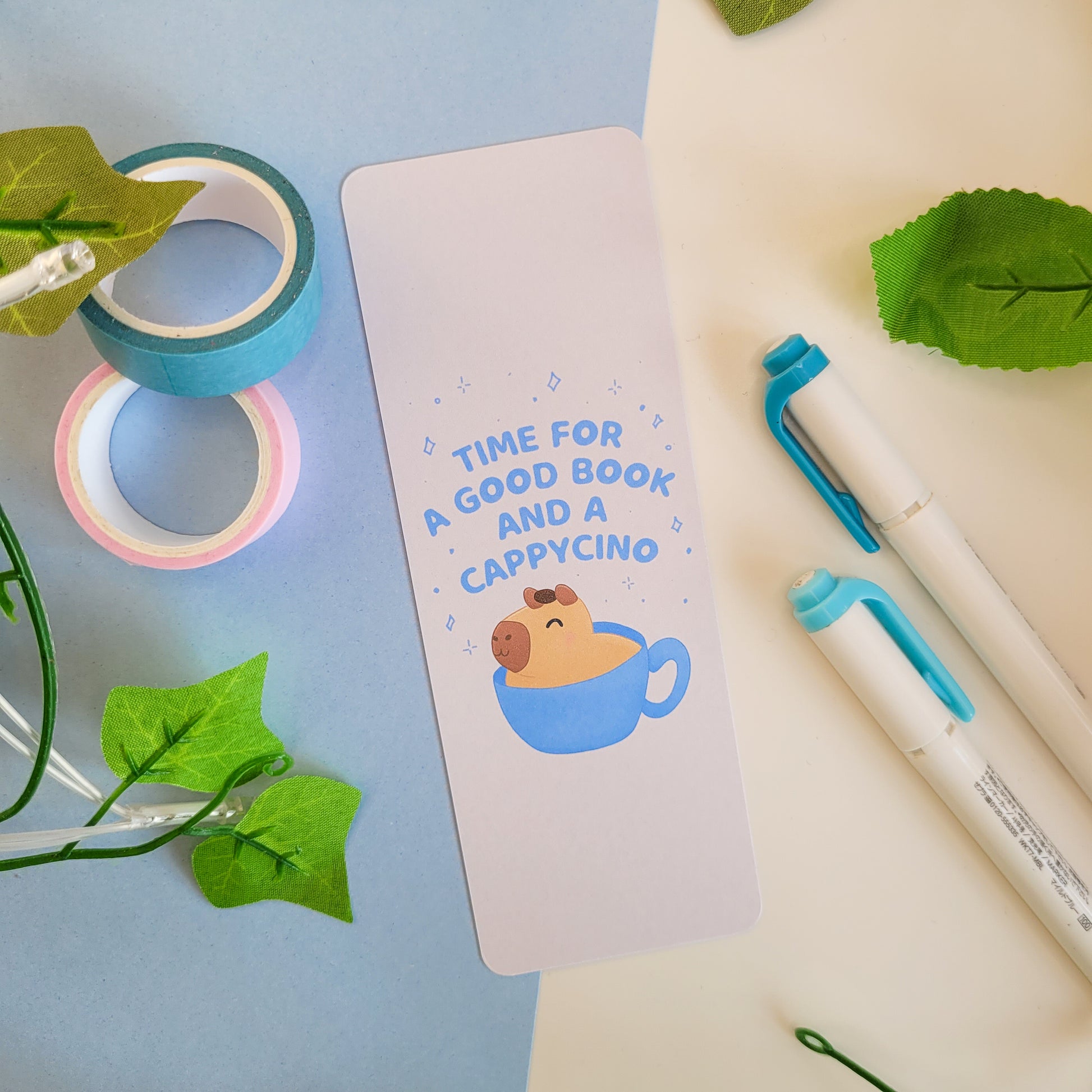 cute bookmark featuring a capybara in a capycino mug and the text: "time for a good book and a capycino"