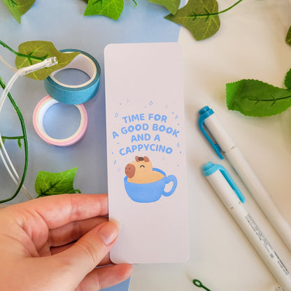 cute bookmark featuring a capybara in a capycino mug and the text: "time for a good book and a capycino"