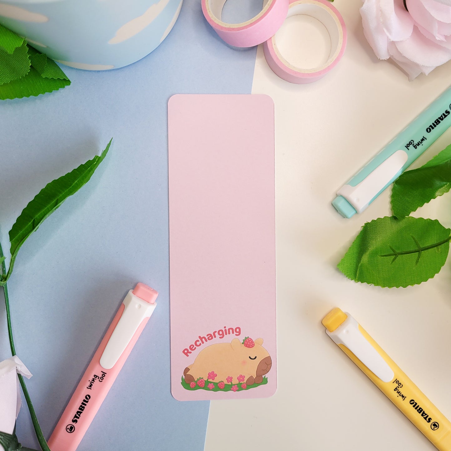 Cute sleeping capybara bookmark featuring the text "Recharging"