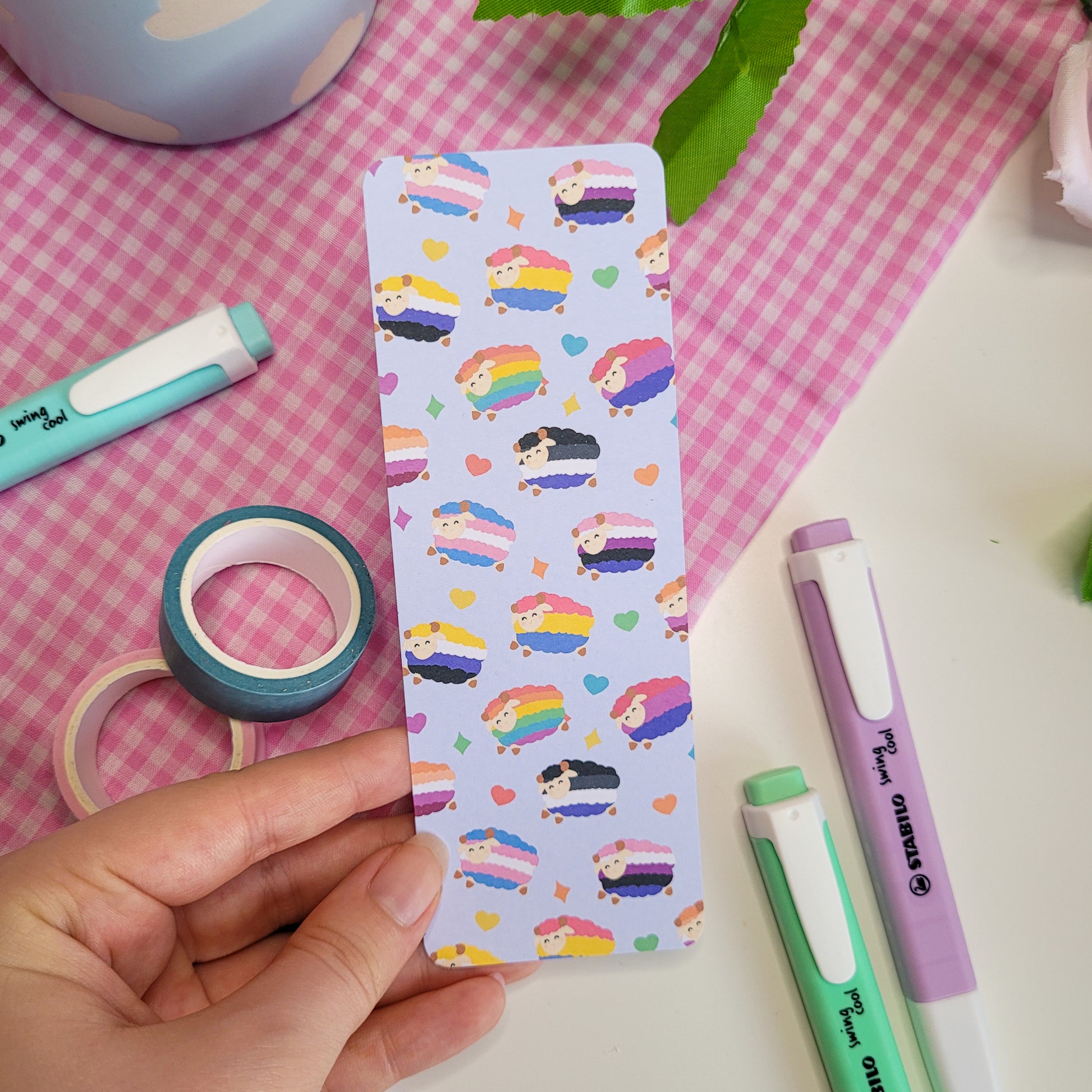 Colourful bookmark featuring a design of sheep with different pride flags on them