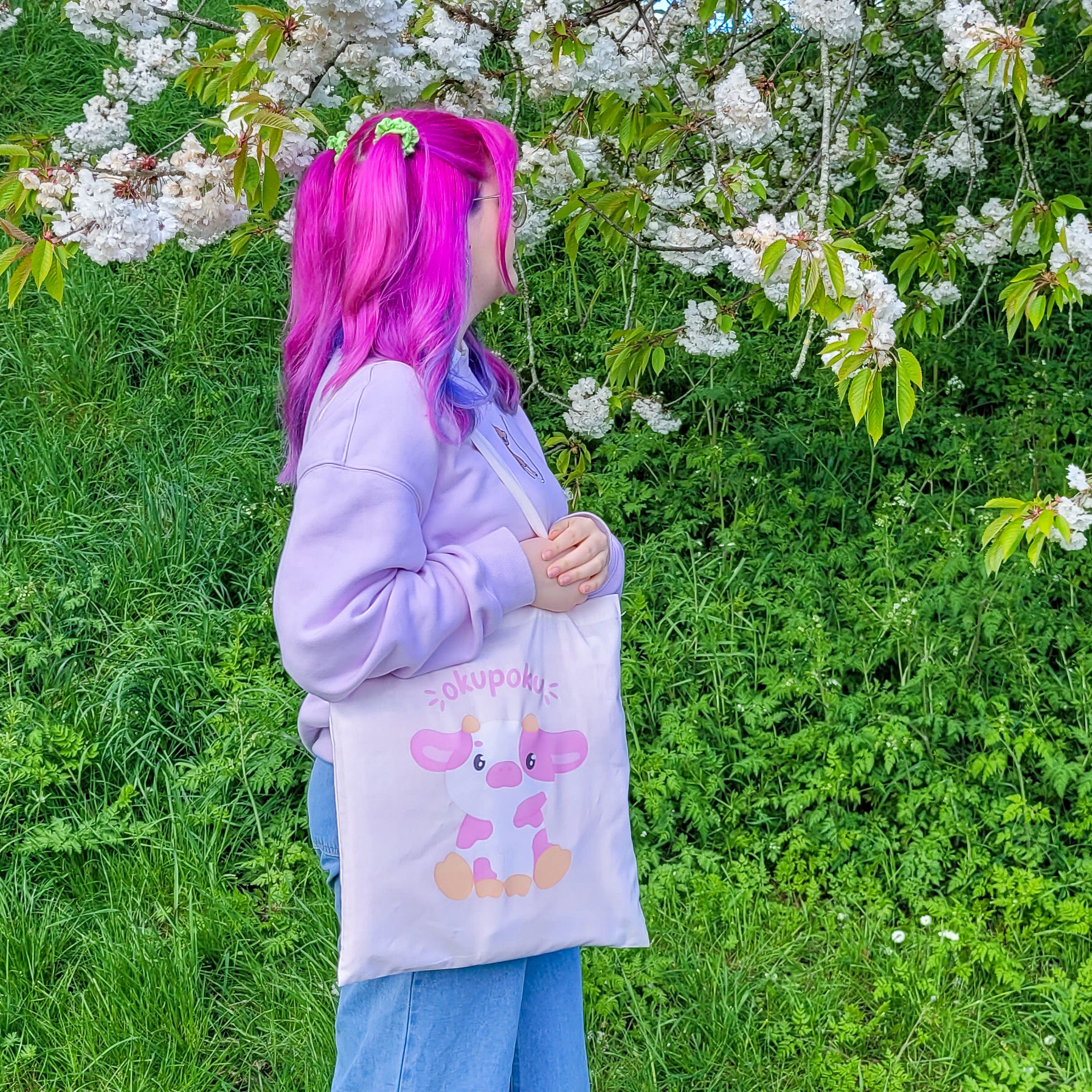 Light pink tote bag featuring an adorable pink cow design and the text okupoku