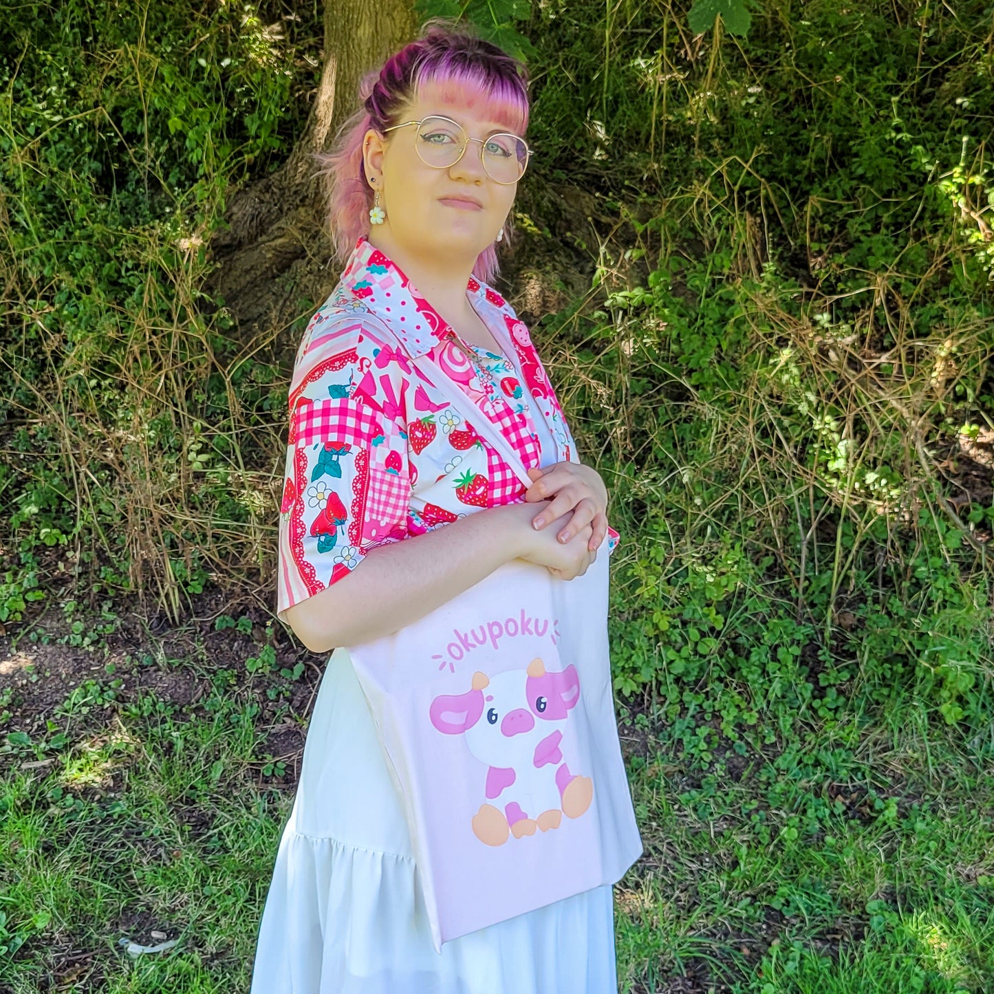 Light pink tote bag featuring an adorable pink cow design and the text okupoku