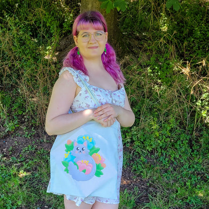 Light mint tote bag featuring a grey cat surrounded by colourful flowers