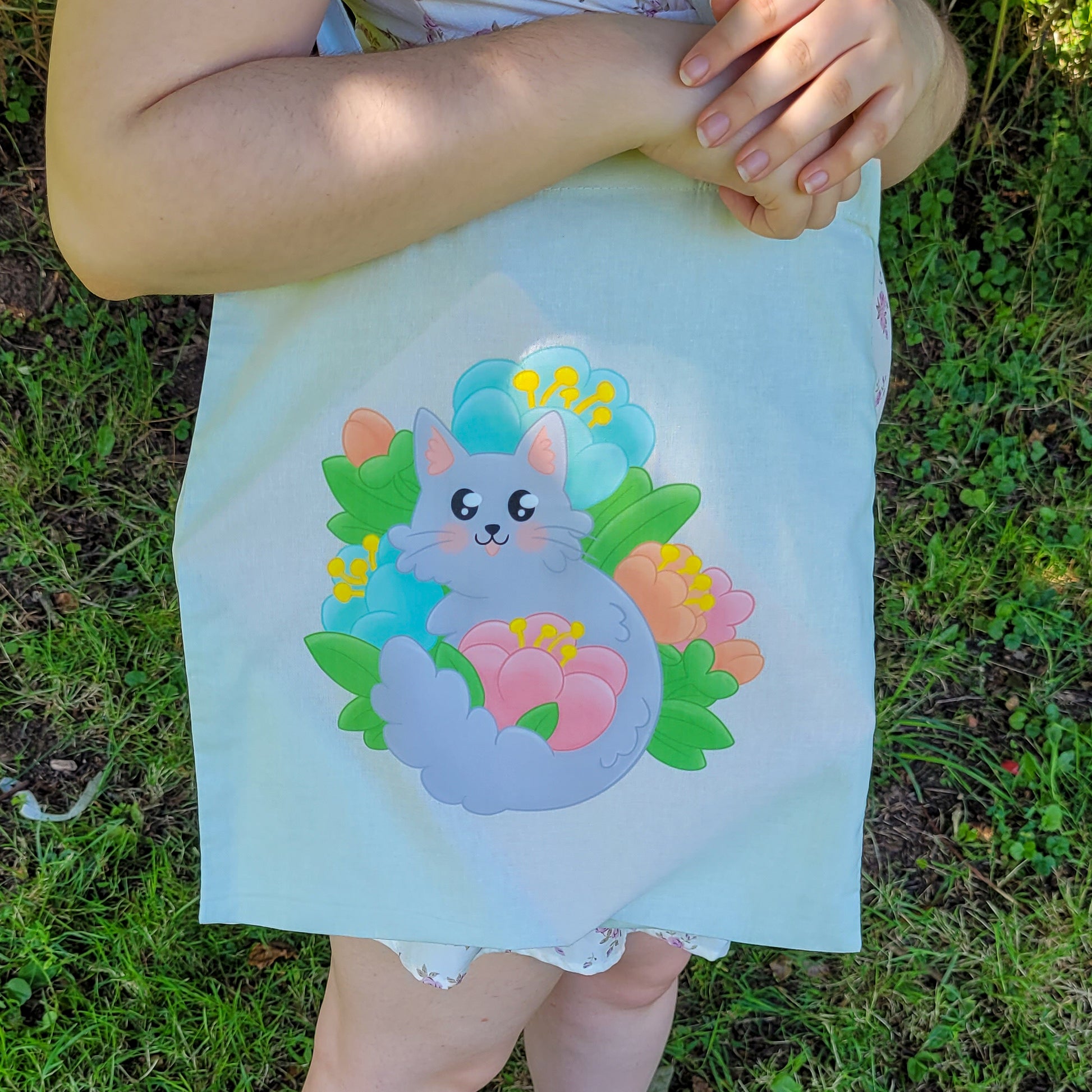 Light mint tote bag featuring a grey cat surrounded by colourful flowers