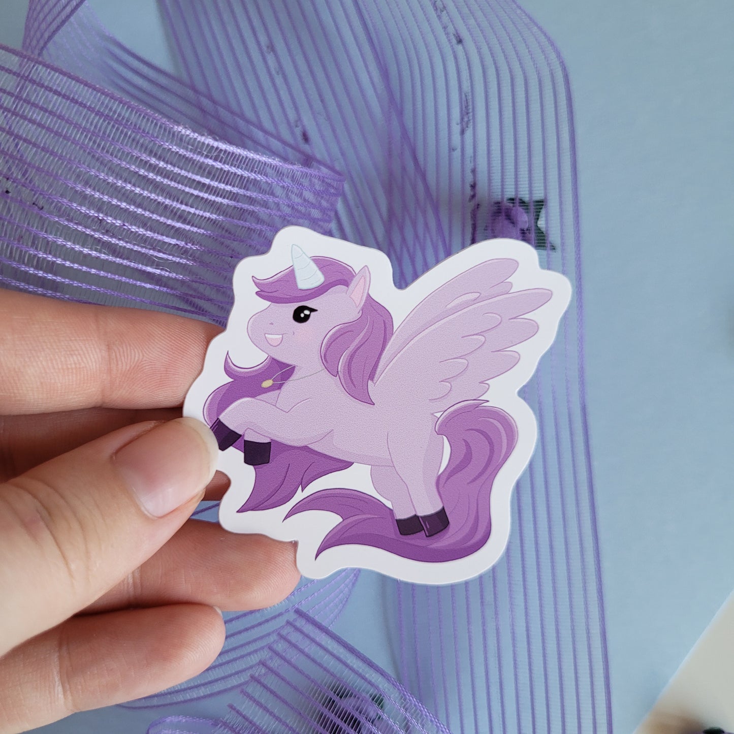 Cute sticker featuring a purple unicorn design