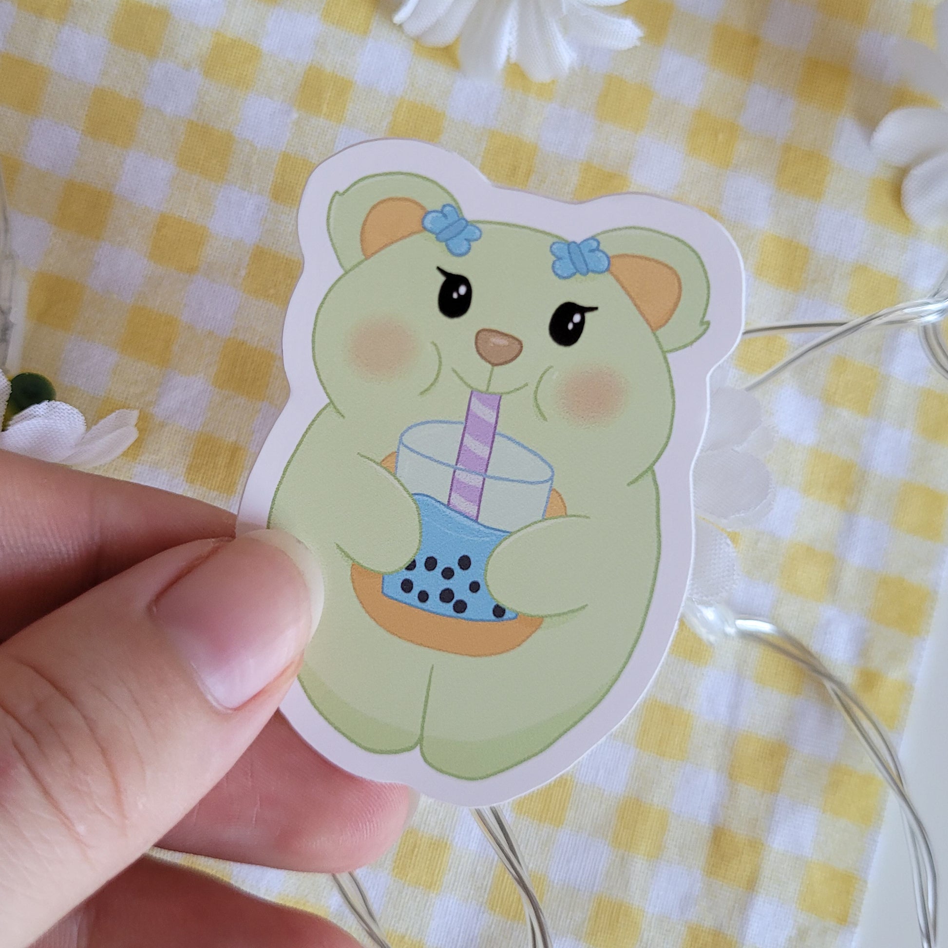 Cute sticker featuing a happy bear holding a bubble tea