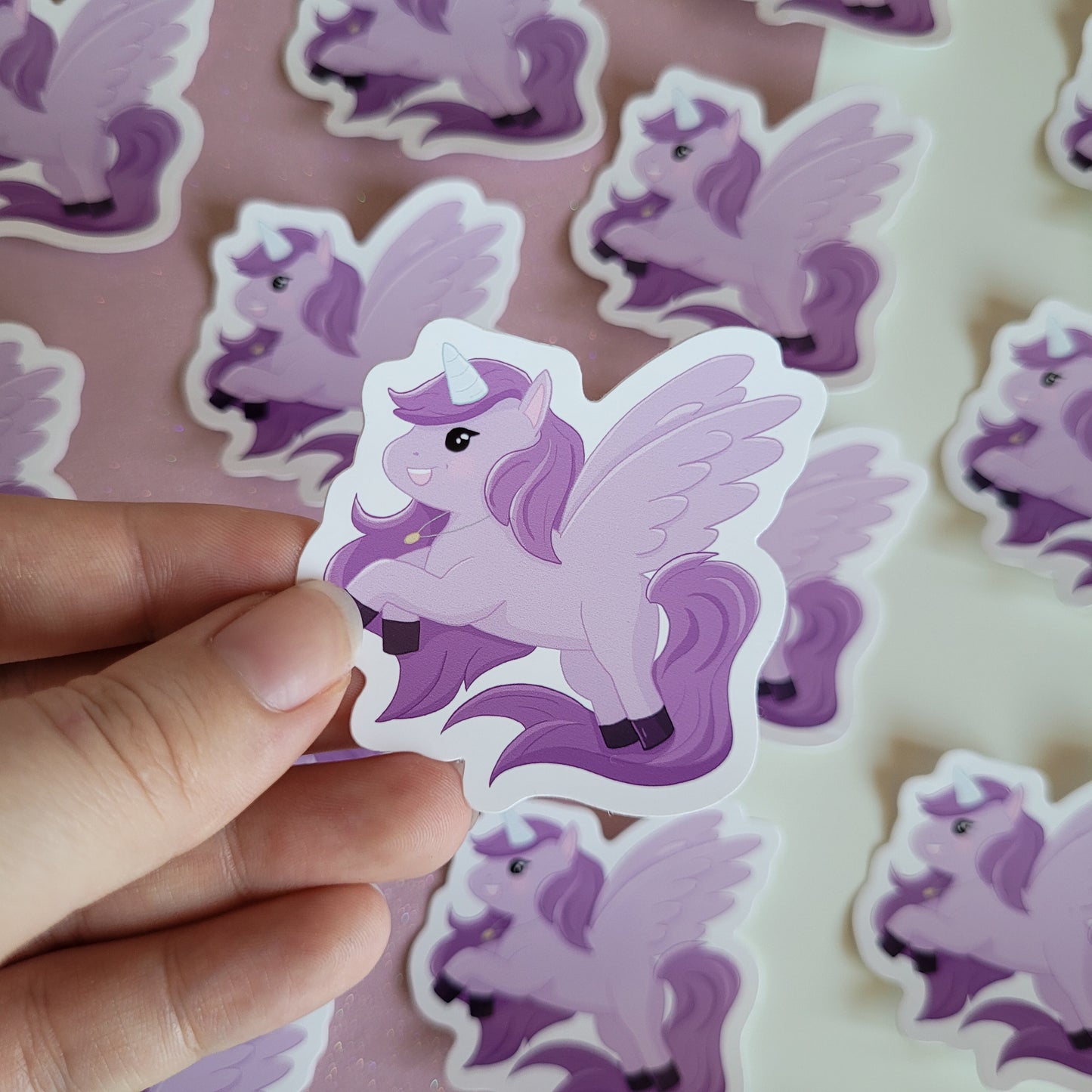 Cute sticker featuring a purple unicorn design