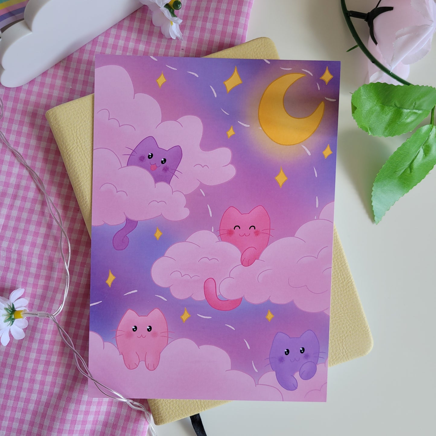 art print poster featuing illustration of pink and purple cats in a night sky