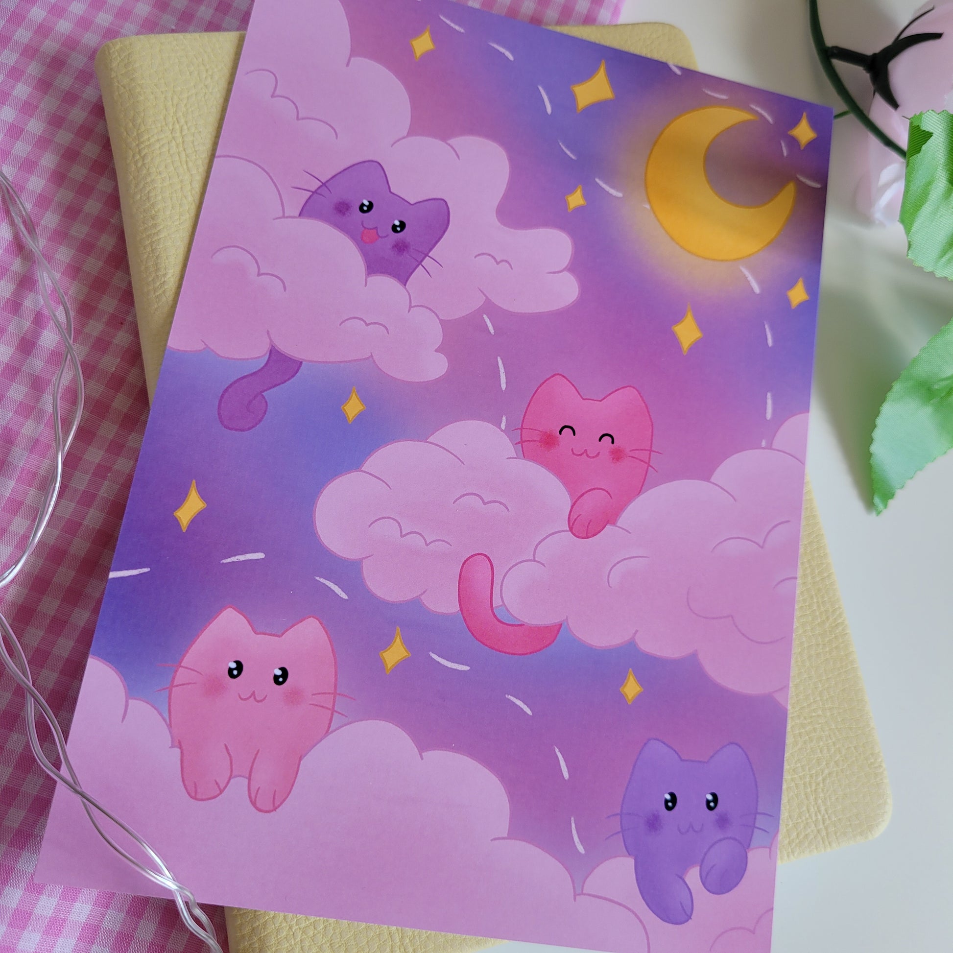 art print poster featuing illustration of pink and purple cats in a night sky