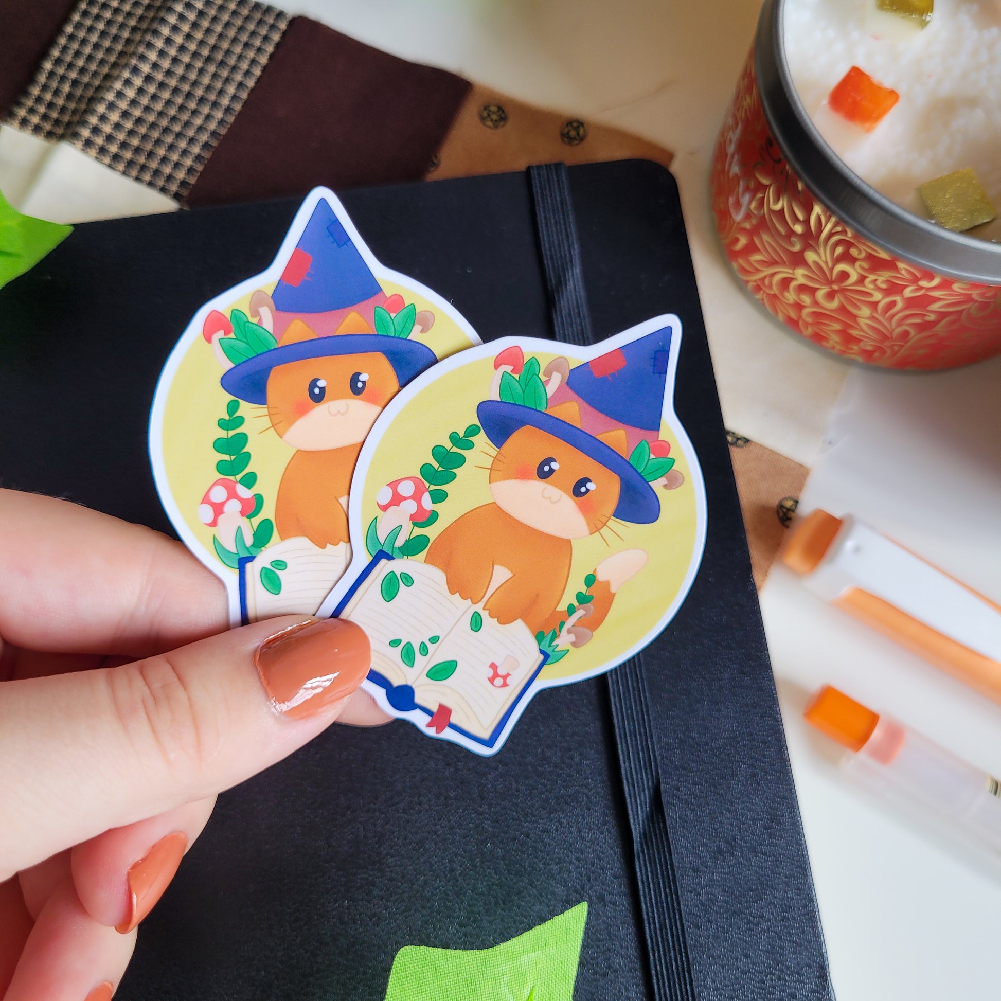 Cute ginger cat in a witch hat reading a spell book, surrounded by mushrooms