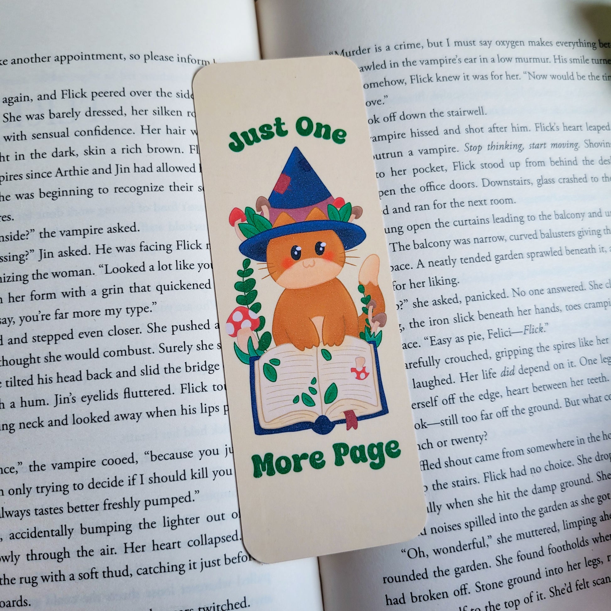 Cute cat witch bookmark featuring the text &quot;Just one more page&quot;