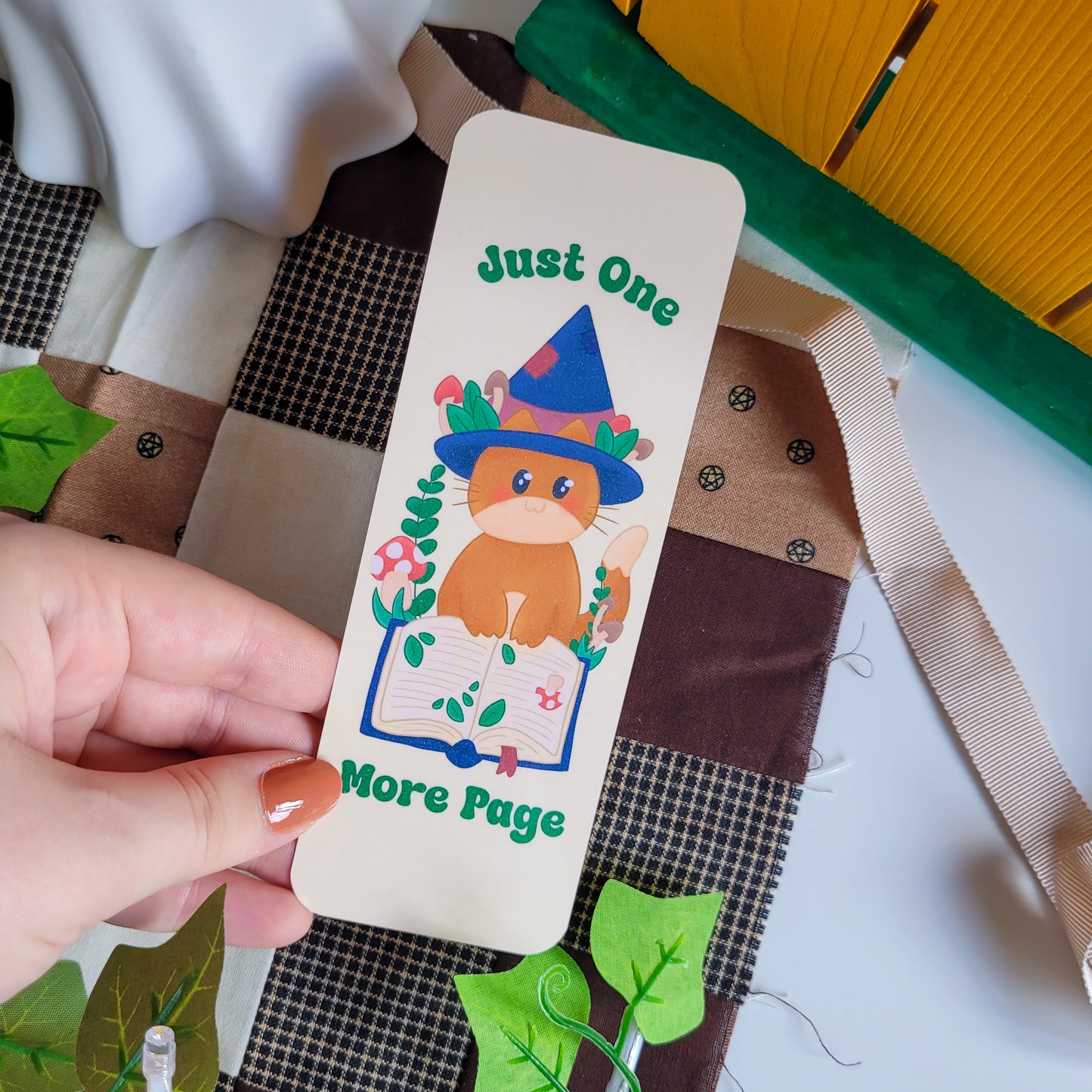 Cute cat witch bookmark featuring the text &quot;Just one more page&quot;