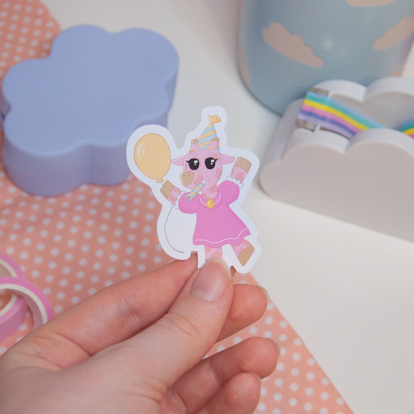 Cute sticker featuring pink giraffe celebrating with a balloon