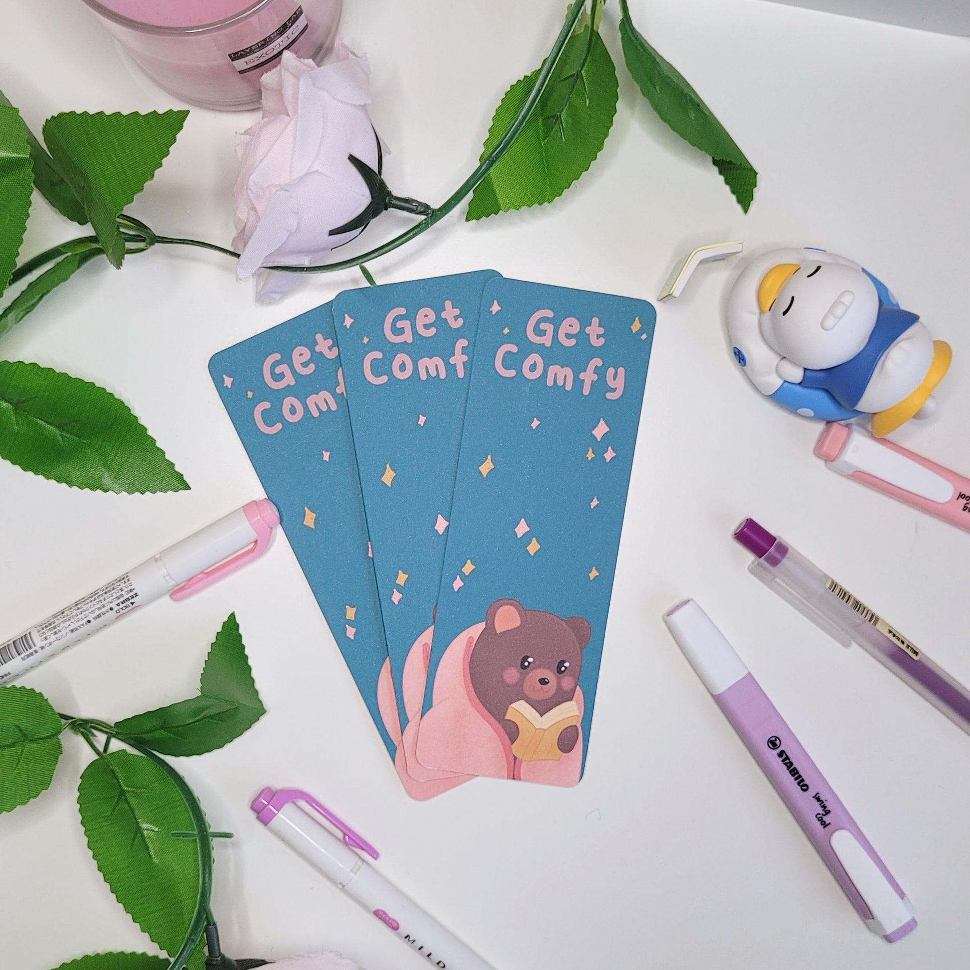 Cute bookmark featuring a bear reading a book and the text "Get Comfy"