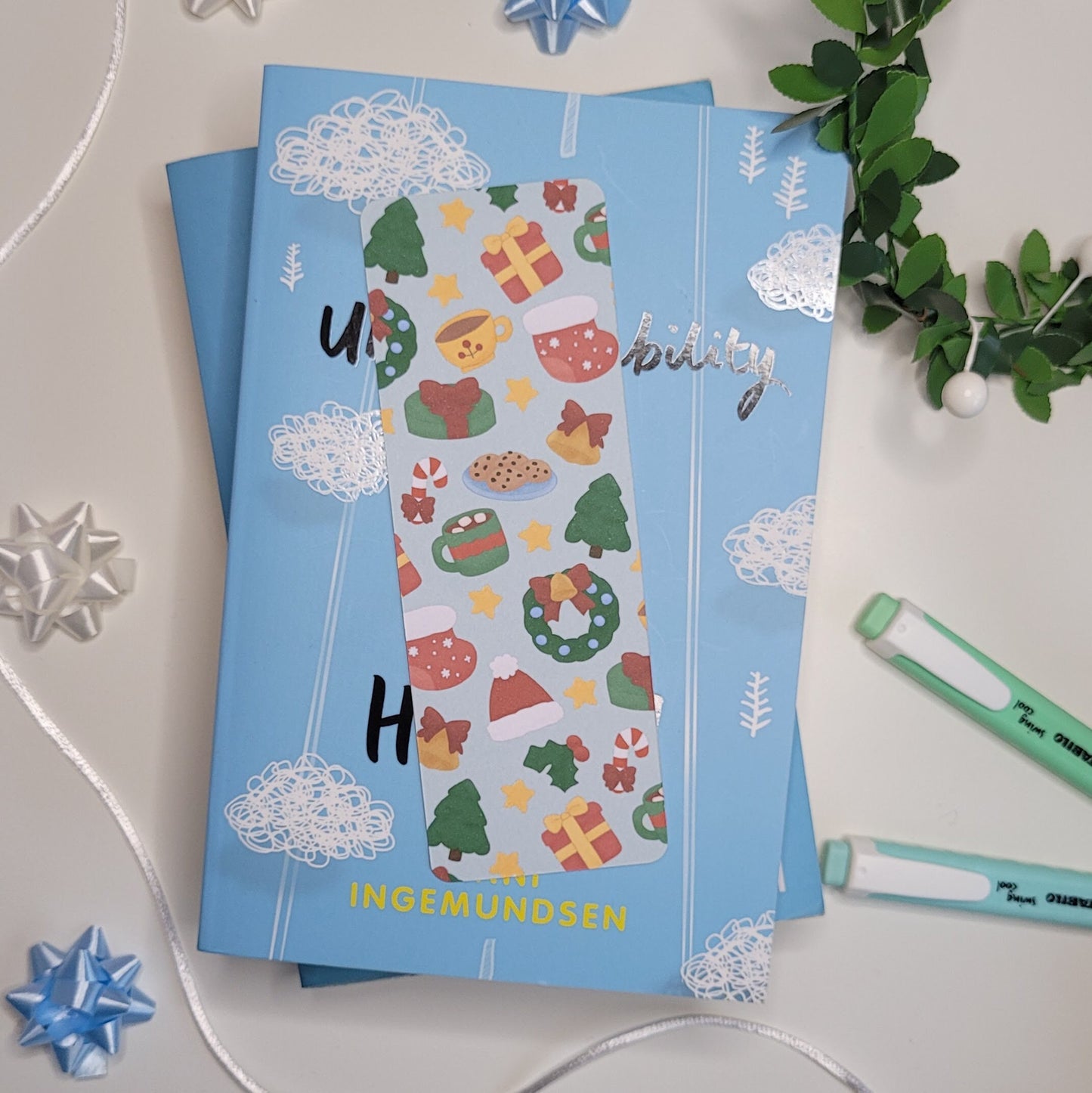 cute christmas themed bookmark featuring a christmas tree, hot chocolate, present, stocking, wreath, santa hat and more