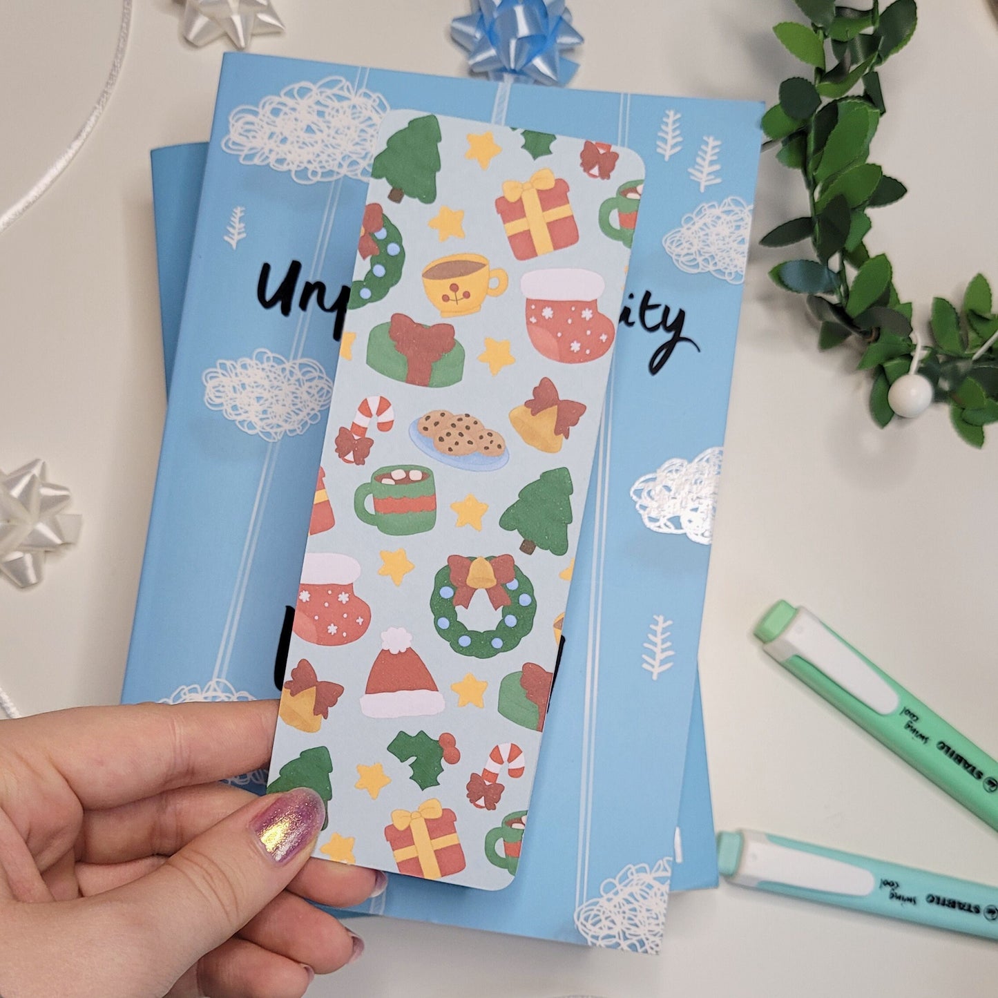 cute christmas themed bookmark featuring a christmas tree, hot chocolate, present, stocking, wreath, santa hat and more