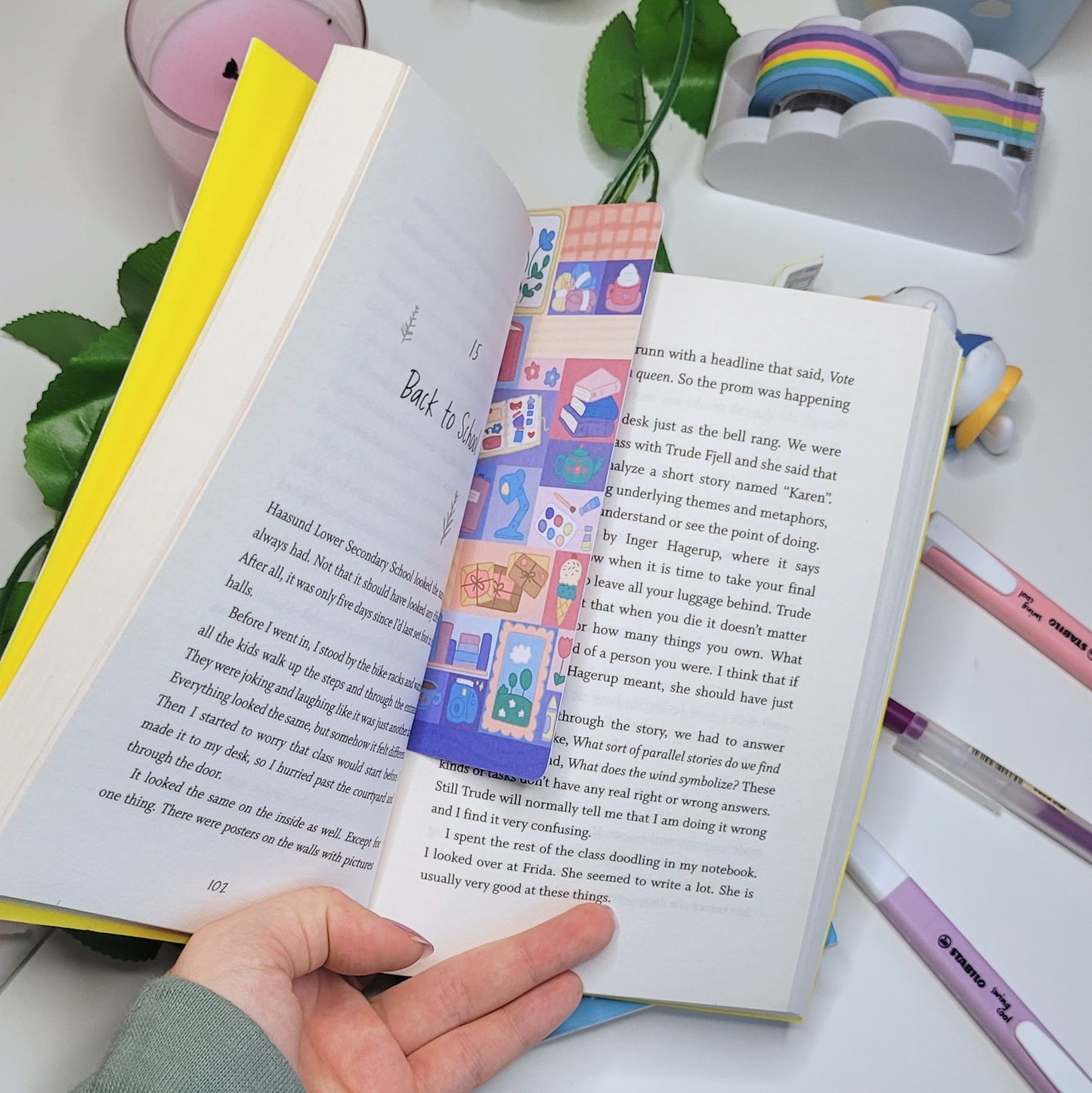 cute bookmark with a patchwork pattern of comfy themed illustrations such as a book, hot chocolate, flowers and more