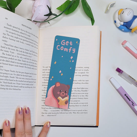 Cute bookmark featuring a bear reading a book and the text "Get Comfy"