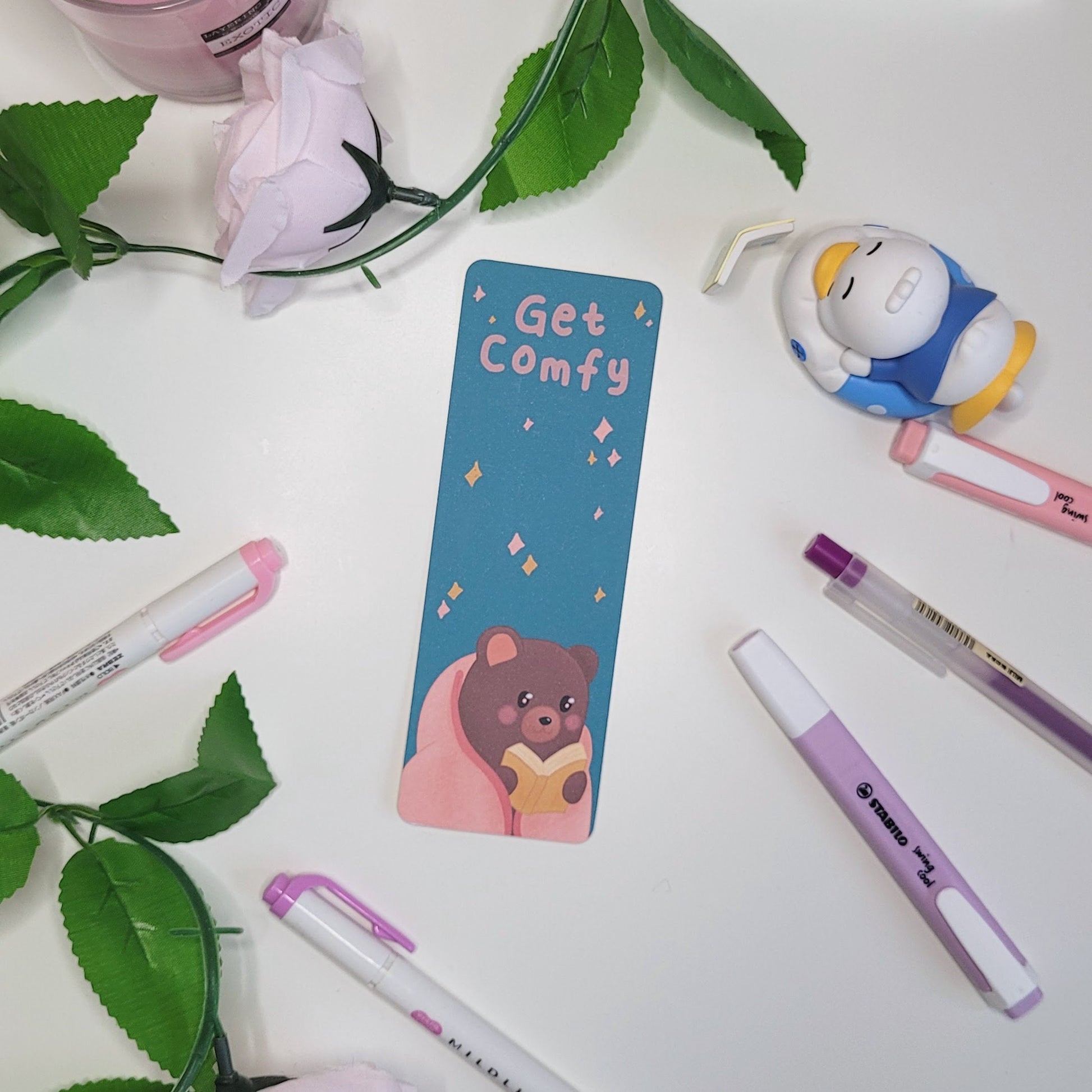 Cute bookmark featuring a bear reading a book and the text "Get Comfy"