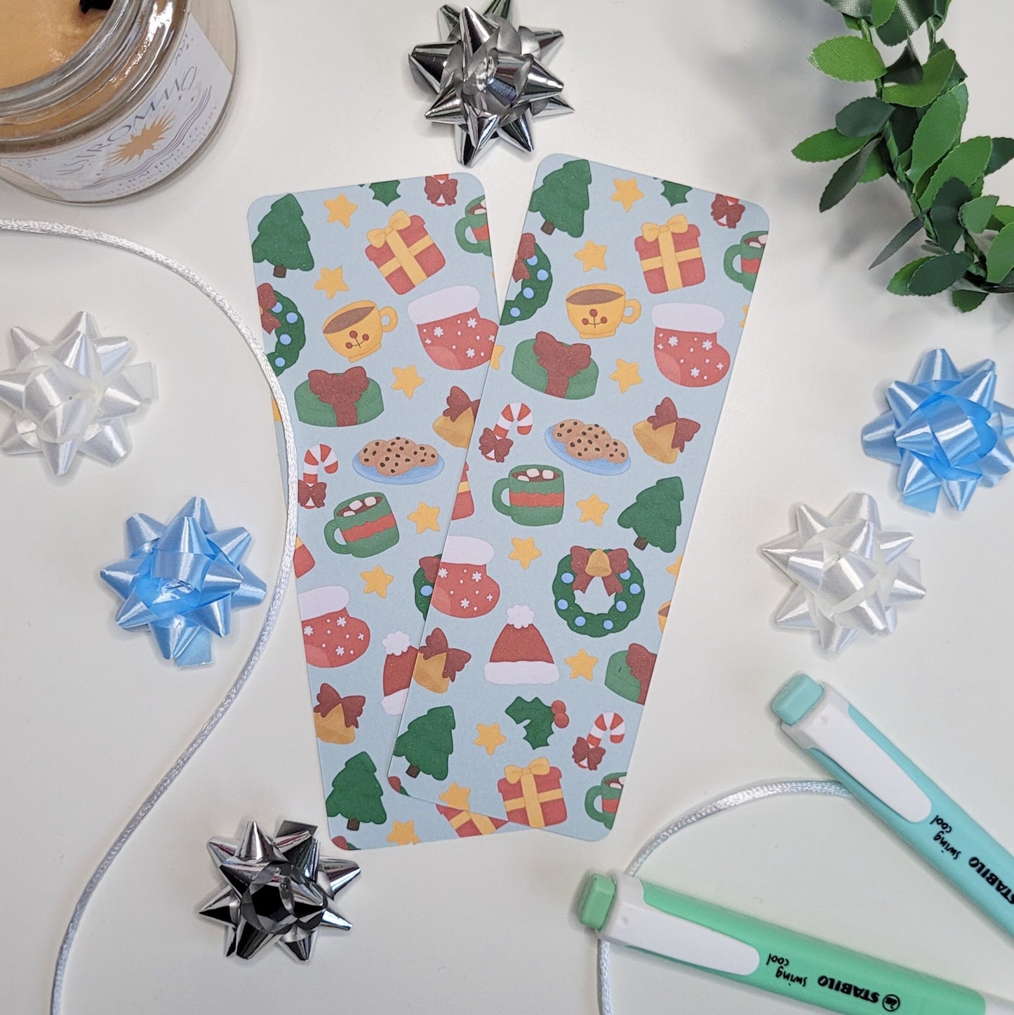 cute christmas themed bookmark featuring a christmas tree, hot chocolate, present, stocking, wreath, santa hat and more