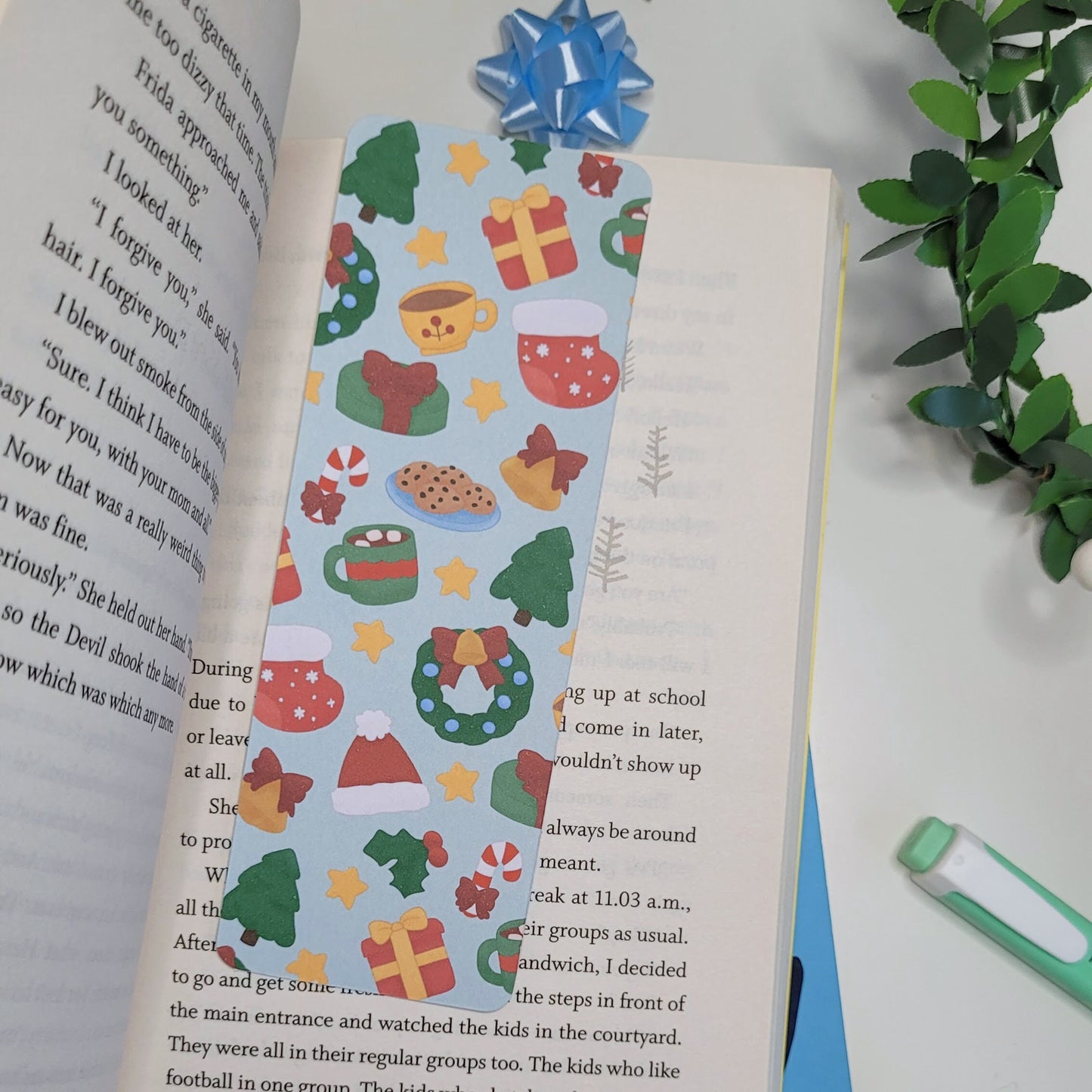 cute christmas themed bookmark featuring a christmas tree, hot chocolate, present, stocking, wreath, santa hat and more