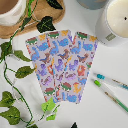 cute bookmark featuring a dinosaur design of brachiosaurus, triceratops, stegosaurus, parasaurolophus and more