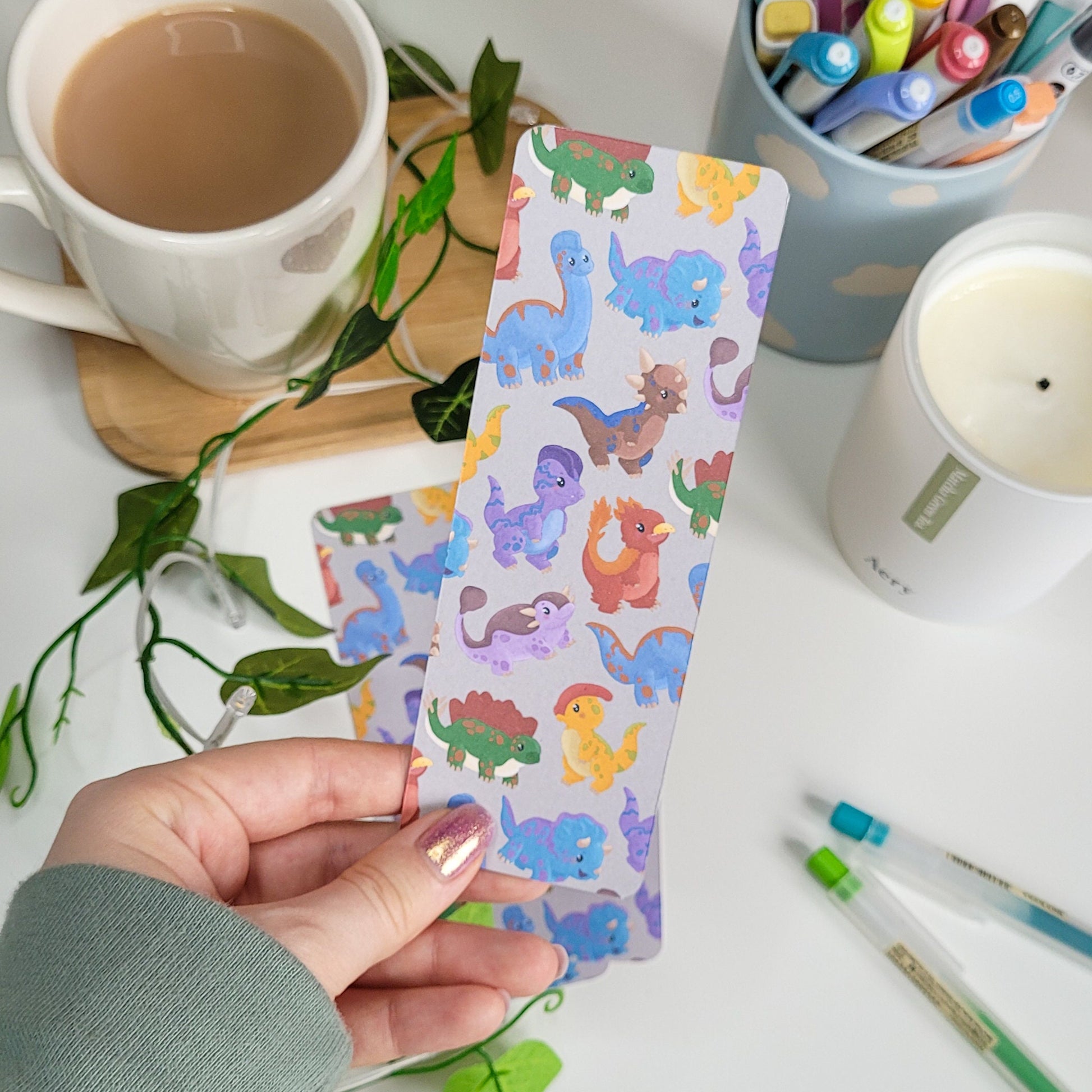 cute bookmark featuring a dinosaur design of brachiosaurus, triceratops, stegosaurus, parasaurolophus and more