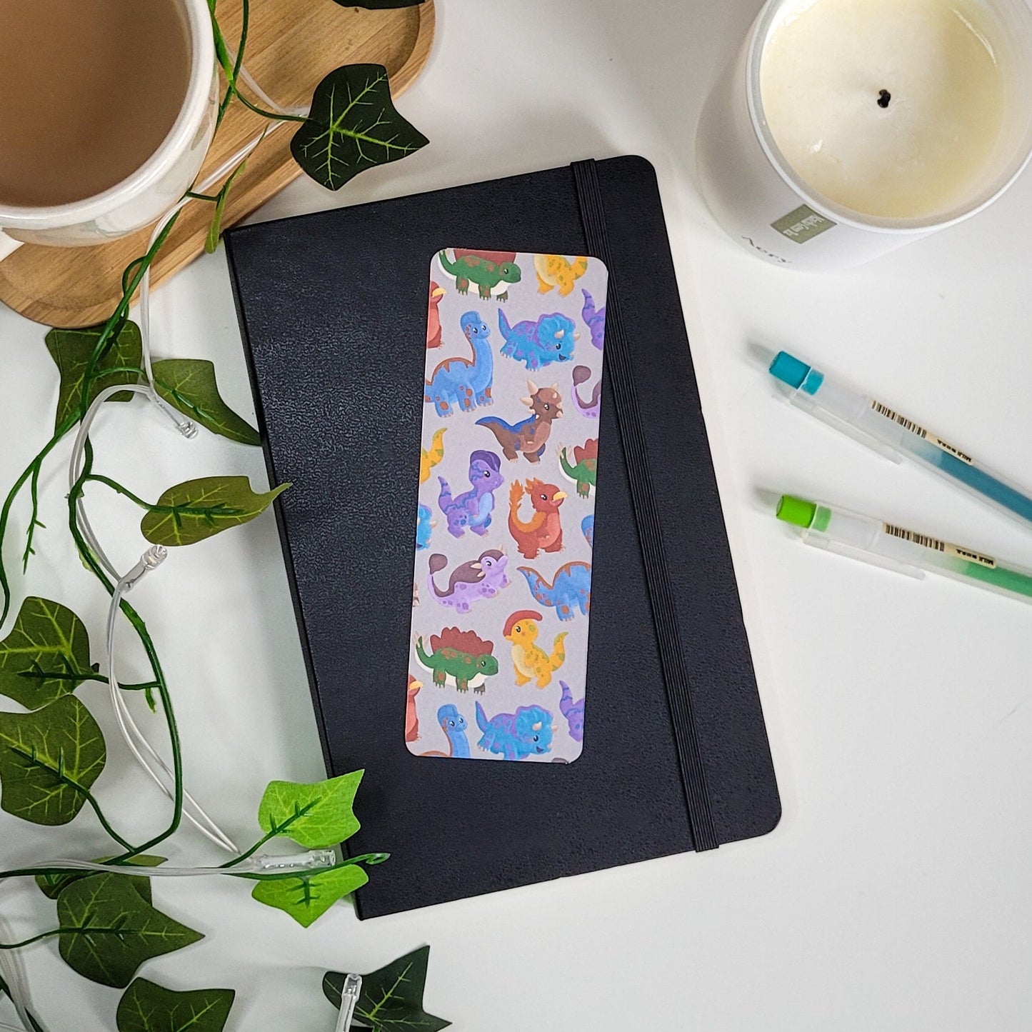 cute bookmark featuring a dinosaur design of brachiosaurus, triceratops, stegosaurus, parasaurolophus and more