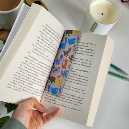 cute bookmark featuring a dinosaur design of brachiosaurus, triceratops, stegosaurus, parasaurolophus and more