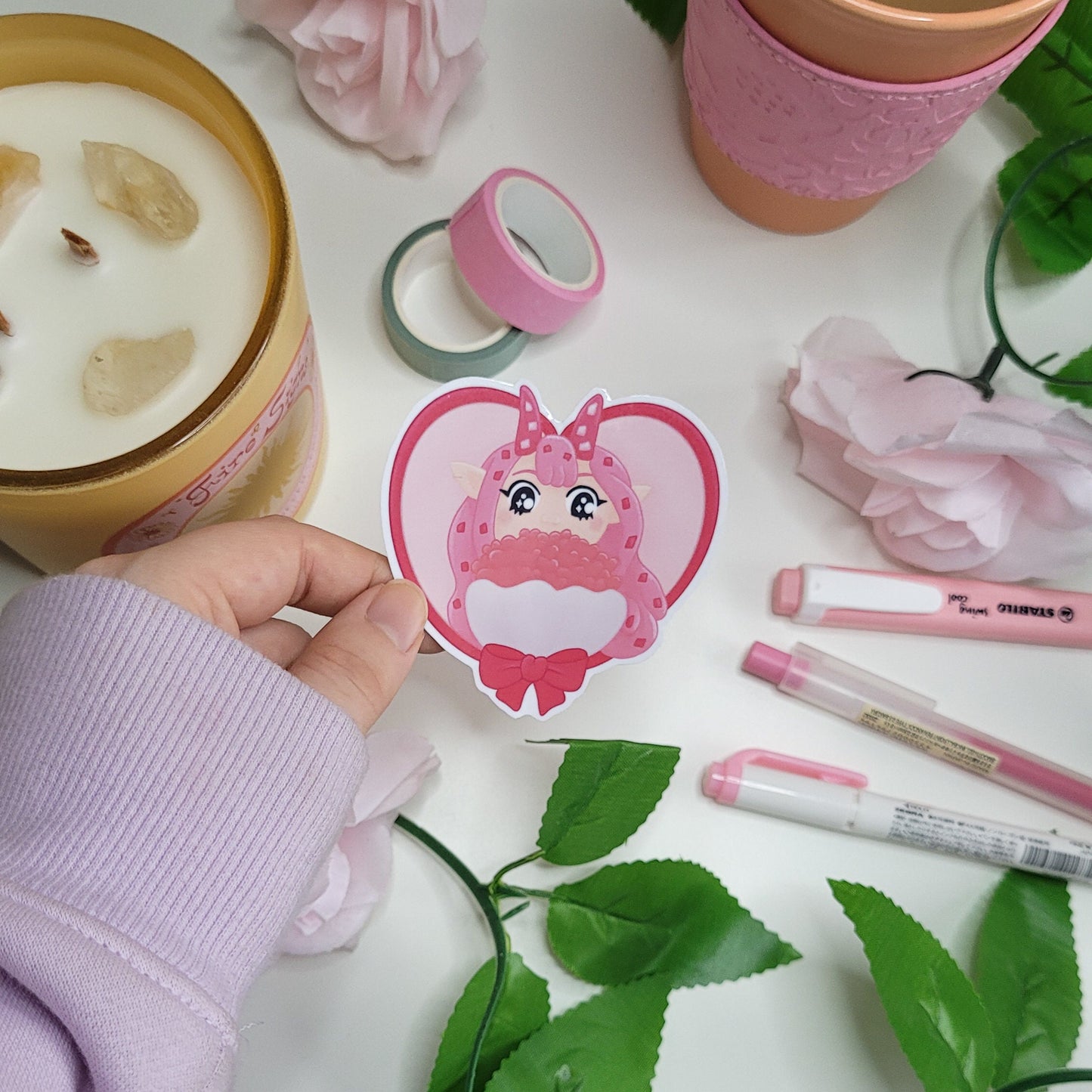 Adorable pink themed heart shape sticker featuring candygirl holding flowers