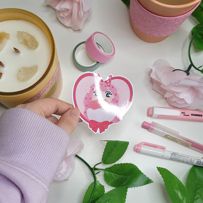 Adorable pink themed heart shape sticker featuring candygirl holding flowers