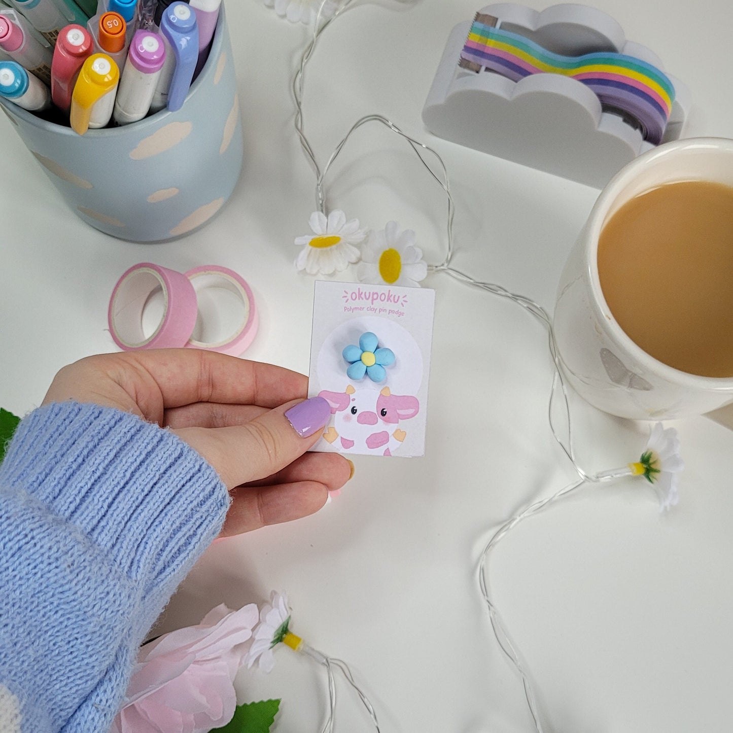 cute handmade blue daisy pin badge made out of polymer clay